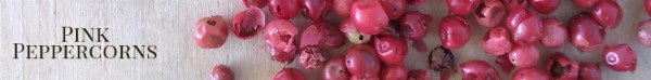 Pink peppercorns on a wood board