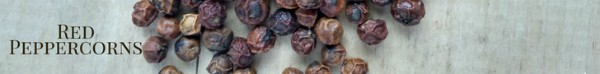 red peppercorns on a wood board