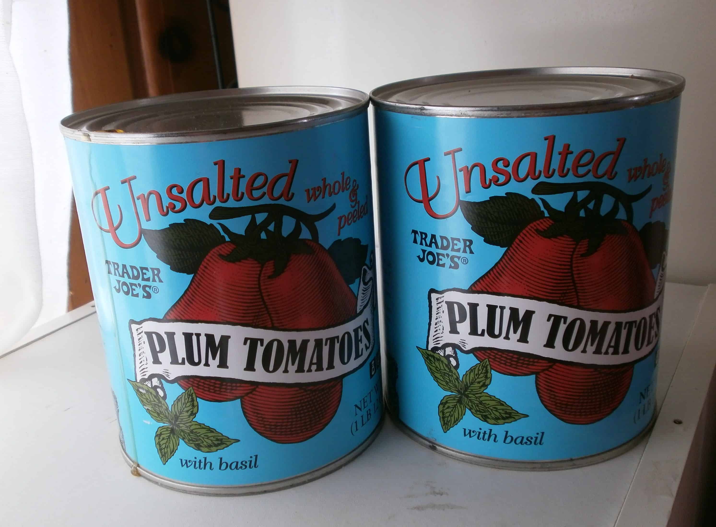 Blue cans of Trader Joe's Unsalted Plum Tomatoes.