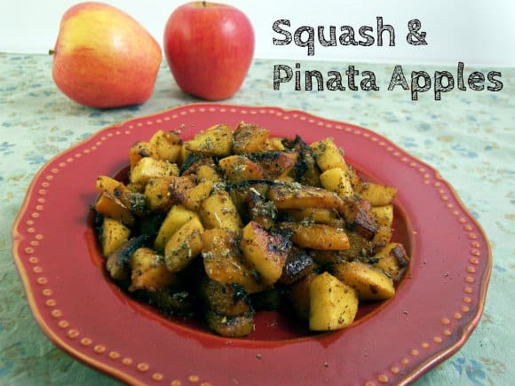 A red plate with pinata apples and butternut squash that have been cubed and cooked together.