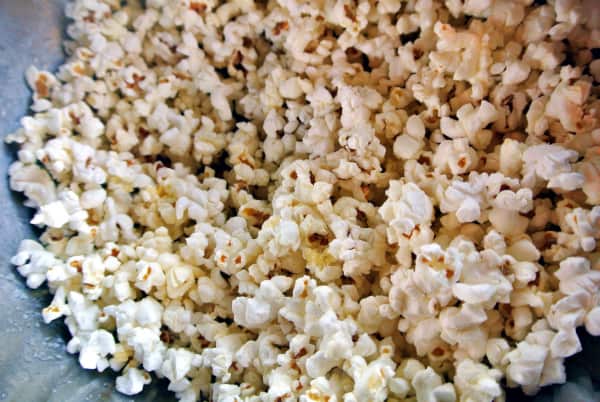 A close up of a bowl of Tiny But Mighty popcorn that has been popped.