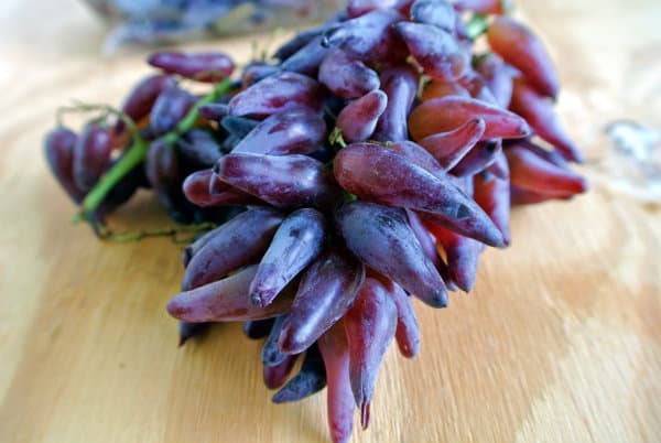 Red Tear Drop Grapes siting on a wood board