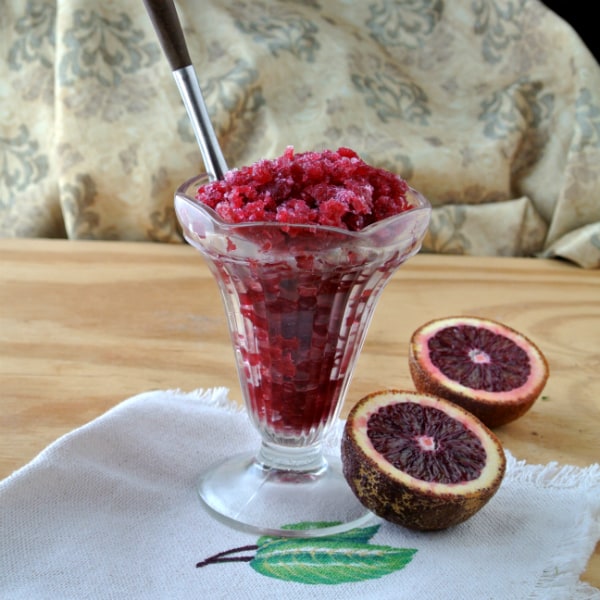 Blood Orange Granita in a glass ice cream sundae cup with a spoon sticking out