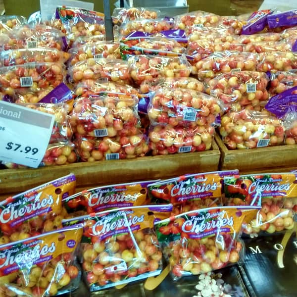 A display at Whole Foods Market of bags of Rainier cherries priced at $7.99 per pound.