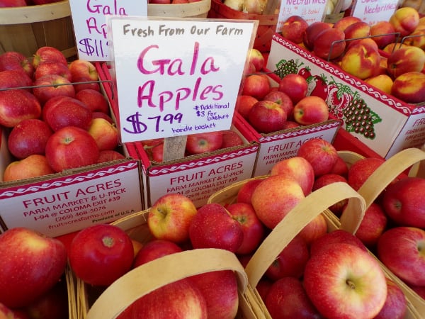 Boxes of Gala apples with a sign saying Fresh From Our Farm" for $7.99 a basket.