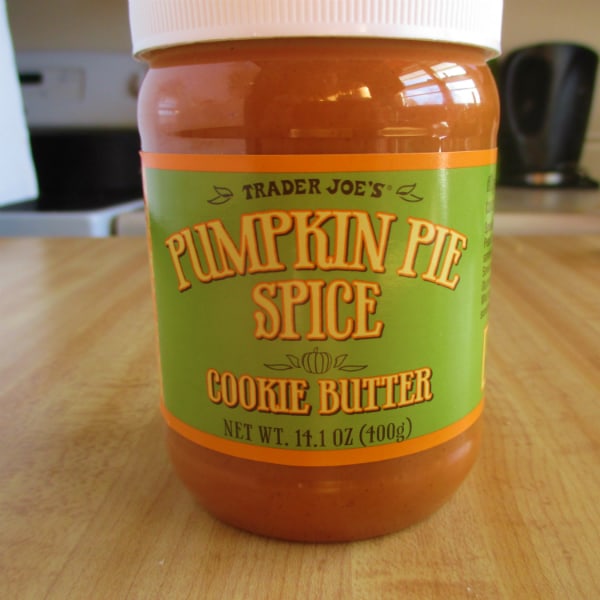 A container of Pumpkin Pie Spice Cookie butter sitting on a table.