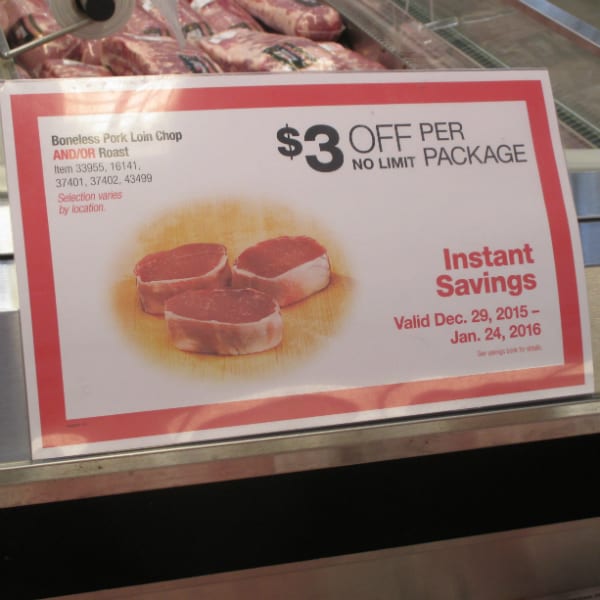 A sign for $3 off per package of pork loin chops at Costco