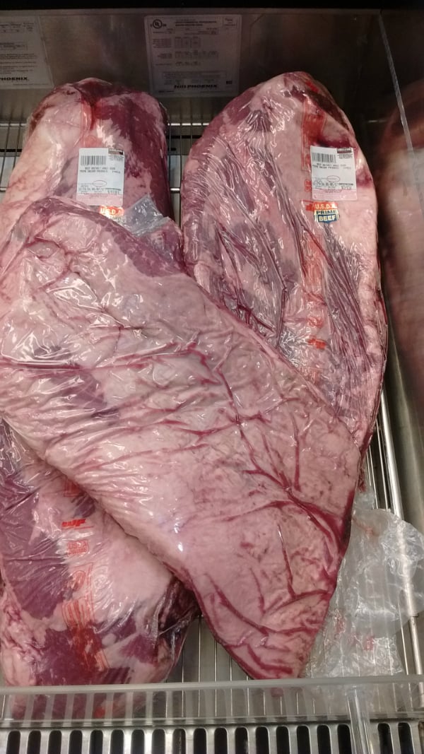 A vacuum sealed USDA Prime whole brisket in a display at a Costco store.