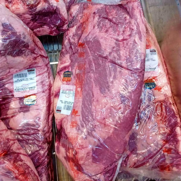 Whole Prime Beef Briskets in vacuum sealed packaging.