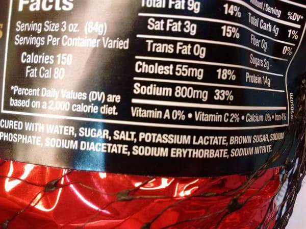 Ingredient list for a Kirklad Brand Costco Spiral Ham is shown on the packaging. The list includes: cured with water, sugar. salt. potassium lactate, brown sugar, sodium phosphate, sodium diacetate, sodium erythorbate, sodium nitrate.