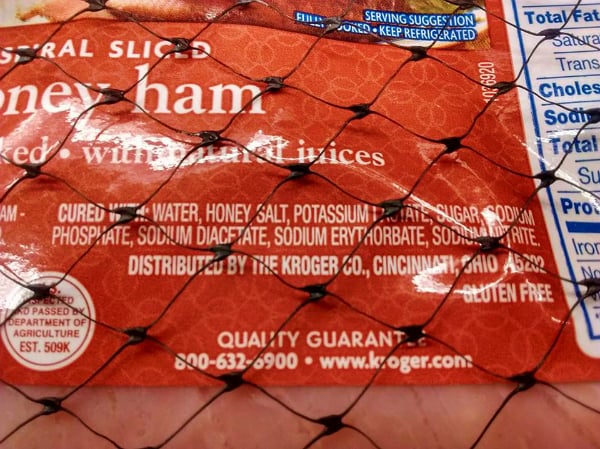 A close of the label of a Kroger Spiral Sliced Honey Ham. Ingredients include: cured with: water, honey, salt, potassium nitrate, sugar, sodium phosphate, sodium diacetate, sodium erythorbate, sodium nitrite.  