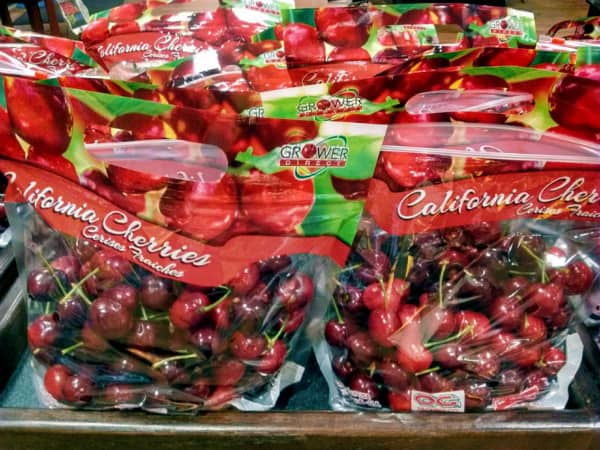 A grocery store display of California Cherries from Grower Direct.