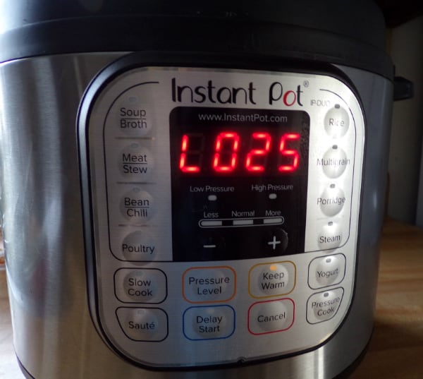 The Instant Pot on a counter reading 25 minutes since the timer ended.