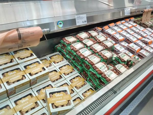 A display at Costco of different types of Gilbert's sausage.