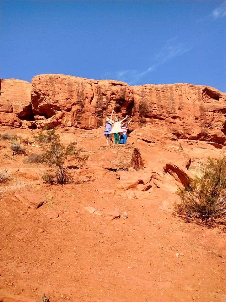 Kids on climbing red rocks