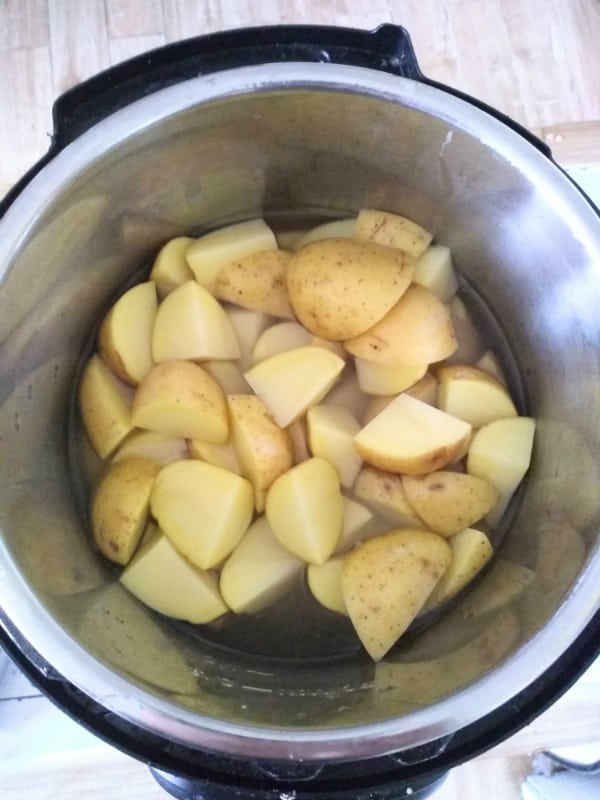 Cut raw gold potatoes inside the Instant Pot.