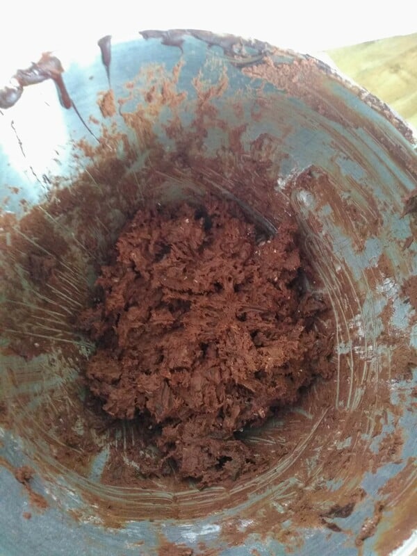 Raw Cookie dough in a stainless steel mixing bowl