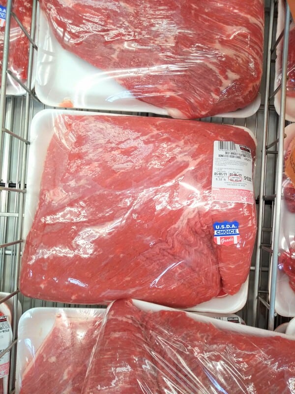 A display of raw boneless flat cut brisket.