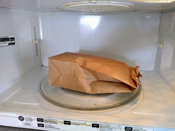 Using a paper bag to make microwave popcorn