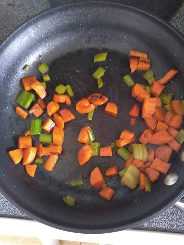 Sauteed carrots and celery in a frying pan