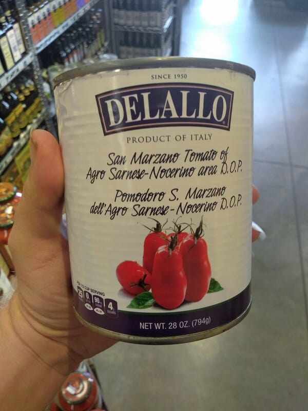 DeLallo DOP San Marzano Tomatoes in a can being held.