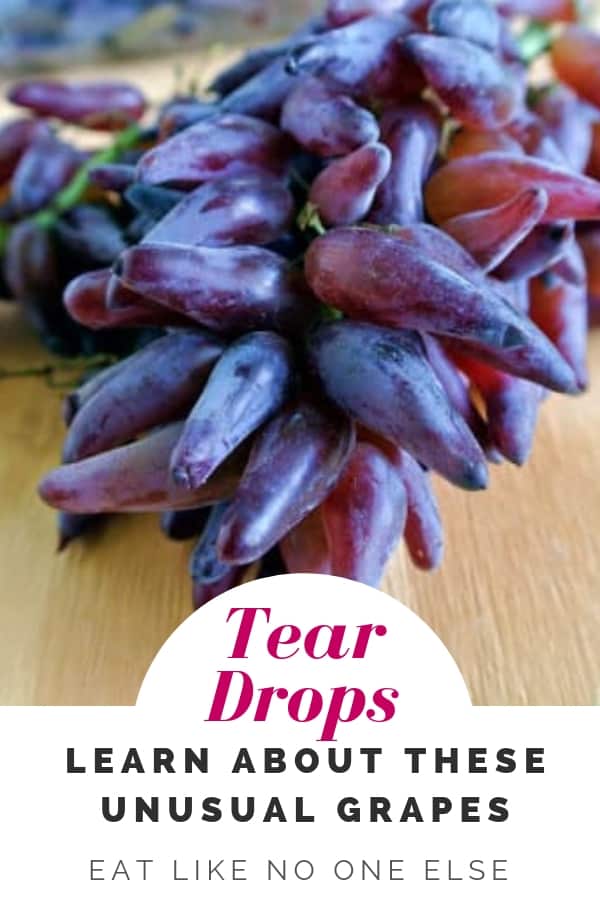 A bunch of Tear Drop red grapes on a counter with the words "Tear Drops" Learn about these unusual grapes.
