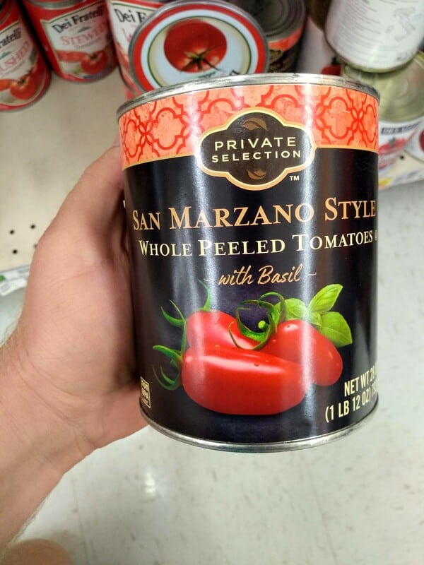 Private Selection Kroger San Marzano Style Tomatoes in a can being held.