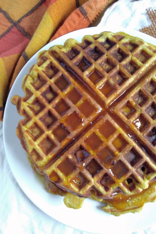 Pumpkin Overnight Yeast Waffles on a plate with syrup