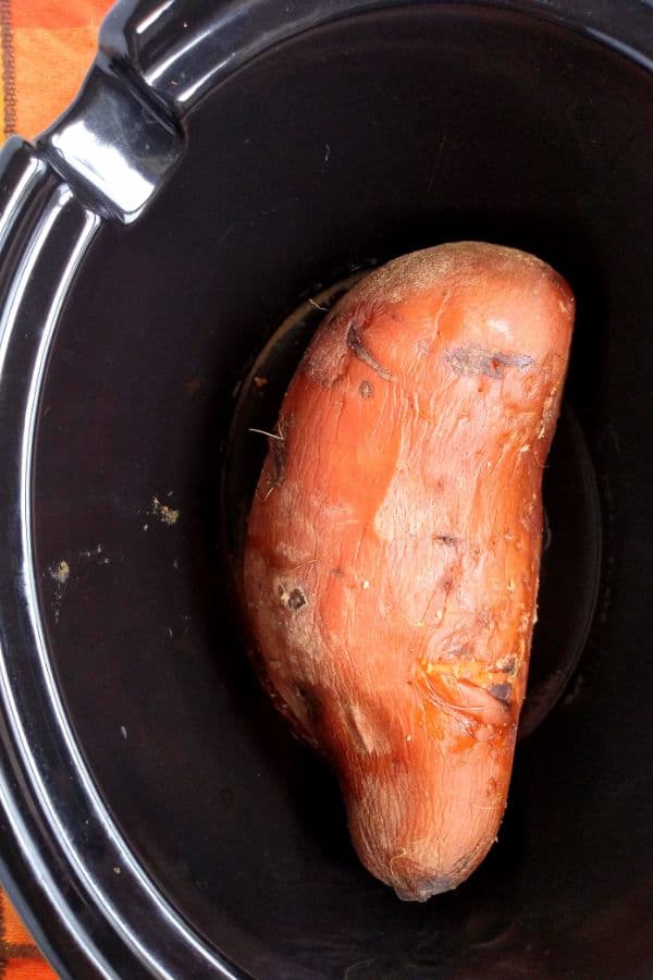 Whole sweet potato cooked in a slow cooker