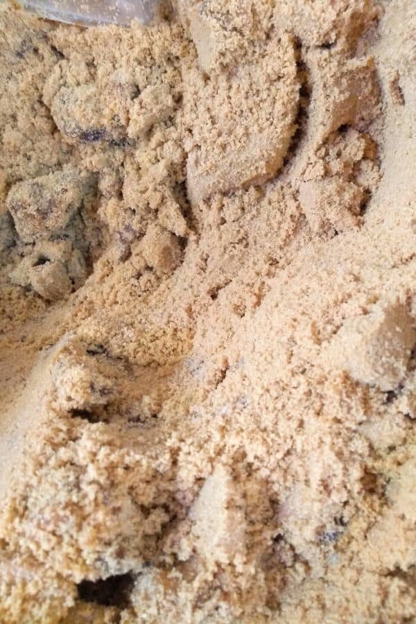 Up close view of Muscovado sugar inside a bin.