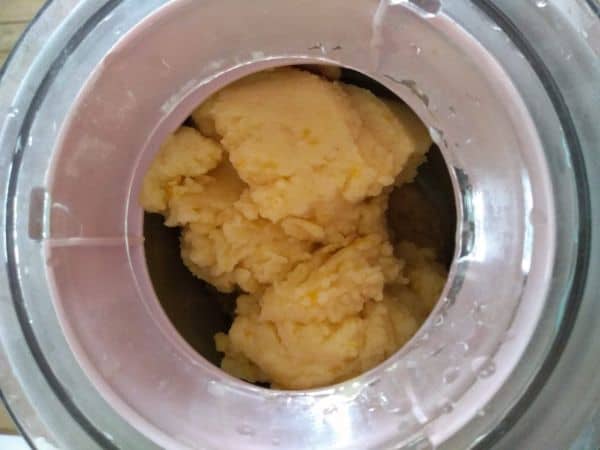 Orange sherbet finished churing in an ice cream maker