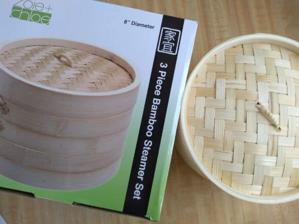 A bamboo steamer basket with box on a table.