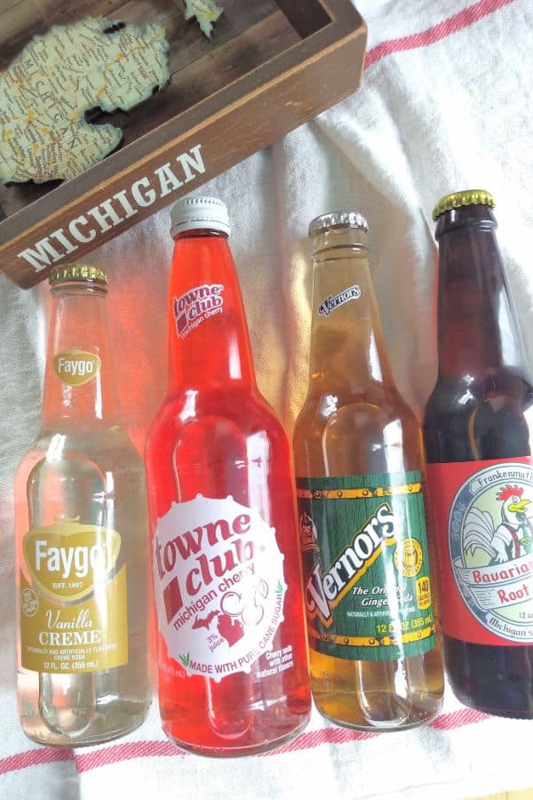 Glass bottle of soda pop, from left to right, Faygo Vanilla Creme, Towne Club Michigan Cherry, Vernors, and Frankenmuth Bavarian Inn Root Beer.