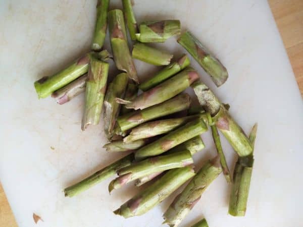 The cut of fends of the asparagus being saved for future use