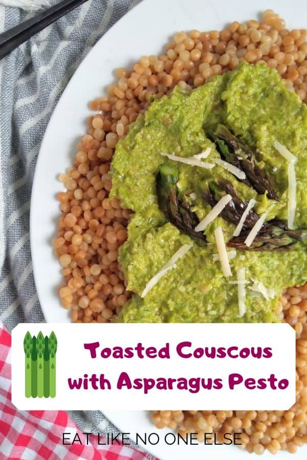 Asparagus pesto with cheese and the tips on asparagus tips served on top of toasted Israeli couscous