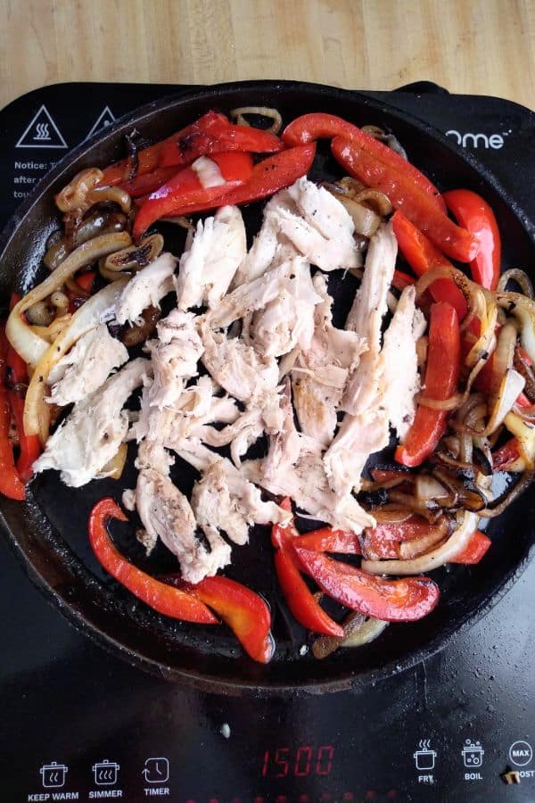 Turkey added to the peppers and onions in the skillet