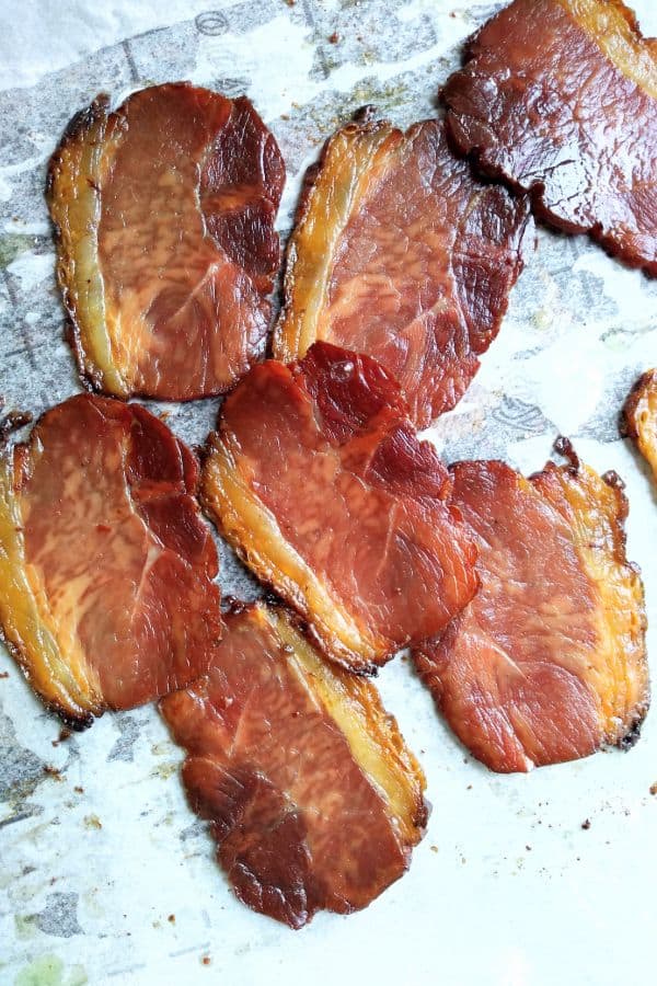 Back bacon that is on a sheet pan lined with parchment paper