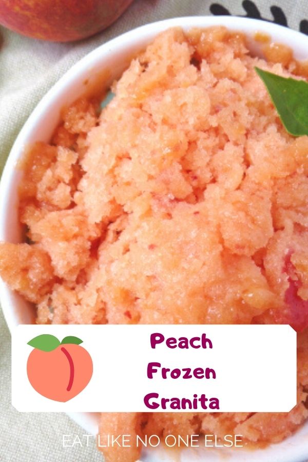 Frozen Peach Granita in a bowl with a mint leave in the top right corer.