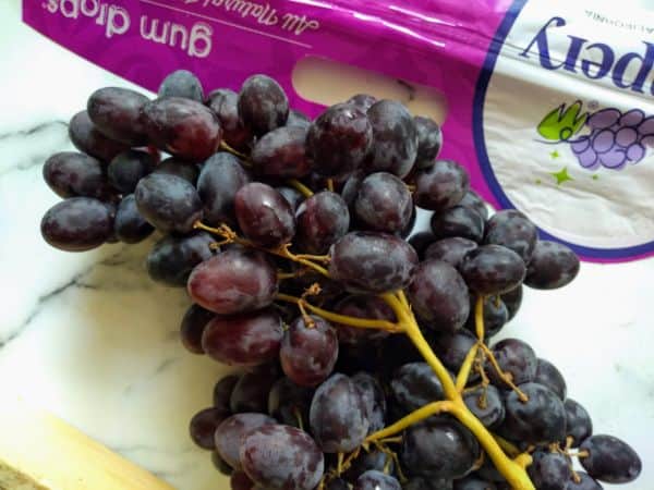 Grapery Gum Drops grapes spilling out of a bag.