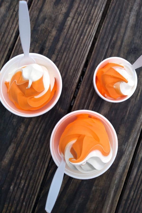 Bowls of orange and vanilla swirled ice cream.