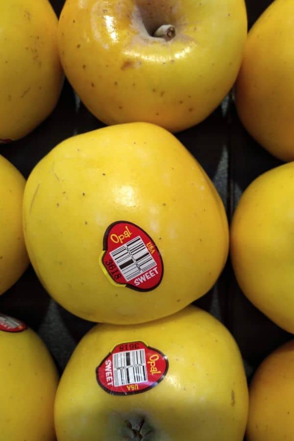 A display of Opal apples at Kroger store. The apples have a red PLU sticker on them that says Opal Sweet.