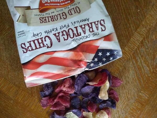 A bag of Saratoga Chips Old Glories spilled out onto a table.