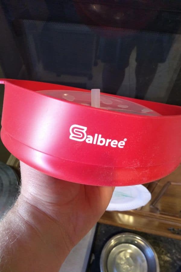 A red Salbree Silicone popcorn popper flatten down.