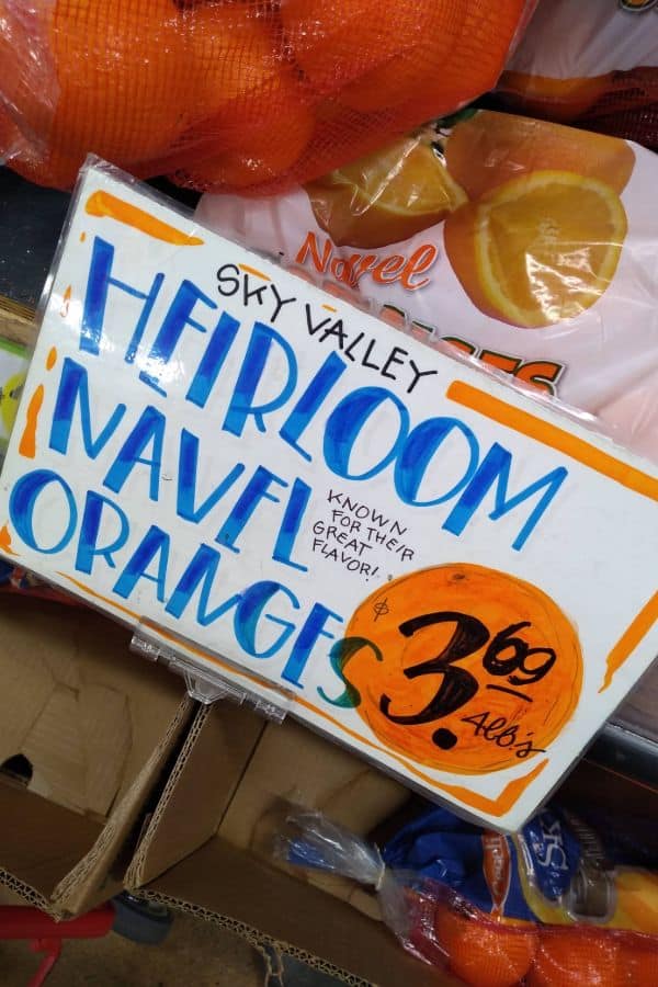 A sign that says Sky Valley Heirloom Navel Oranges are $3.69 a bag.