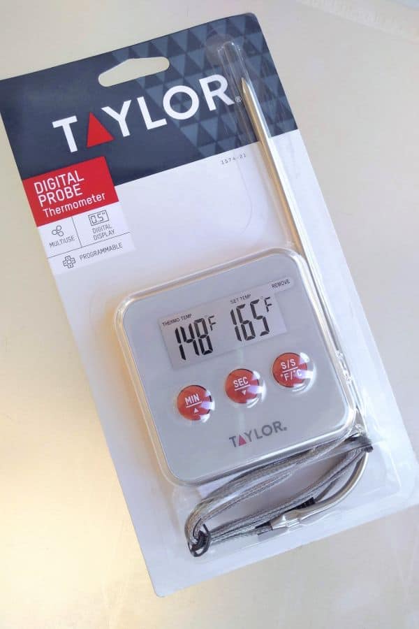 A Taylor Digital Probe thermometer in it's packaging from the store on a white surface.