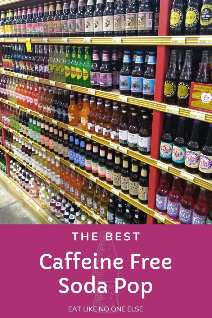 A display of glass bottled soda in a grocery store with the words "the Best Caffeine Free Soda Pop" at the bottom.