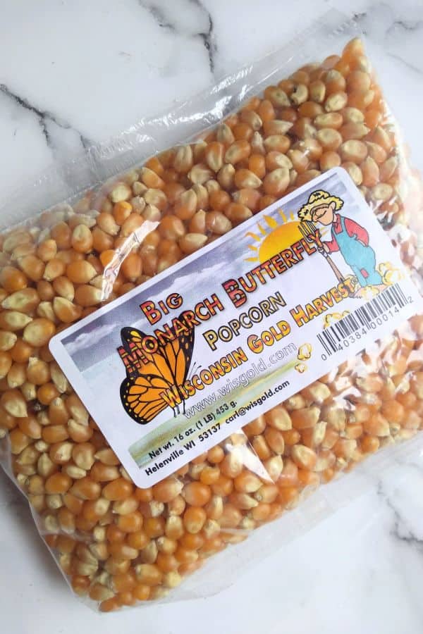 A package of Big Monarch Butterfly Popcorn by wisconsin gold harvest sitting o a white counter. 