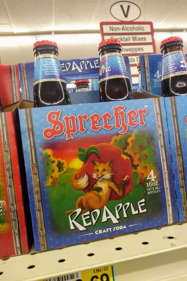 A 4 pack of Sprecher Red Apple soda on a grocery store shelf.