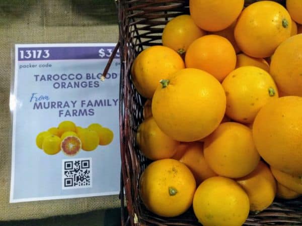 A basket of Tarocco blood oranges with a sign saying they are from Murray Family Farms.