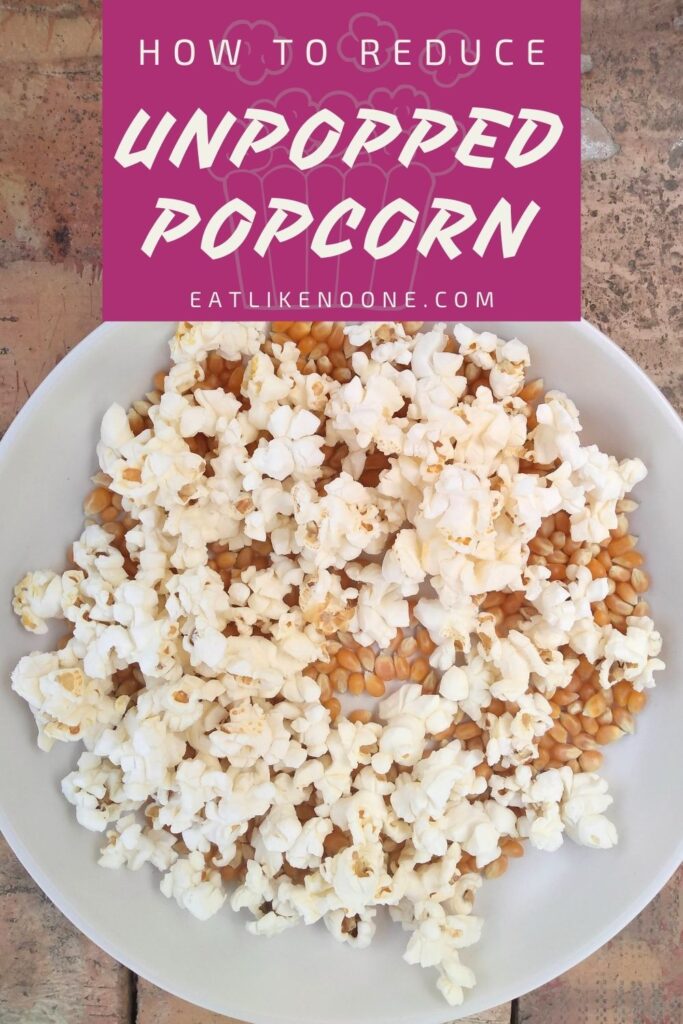 A bowl of popcorn full of popped and unpopped kernels with the words "How to Reduce Unpopped Popcorn" in a magenta box at the top of the photo.